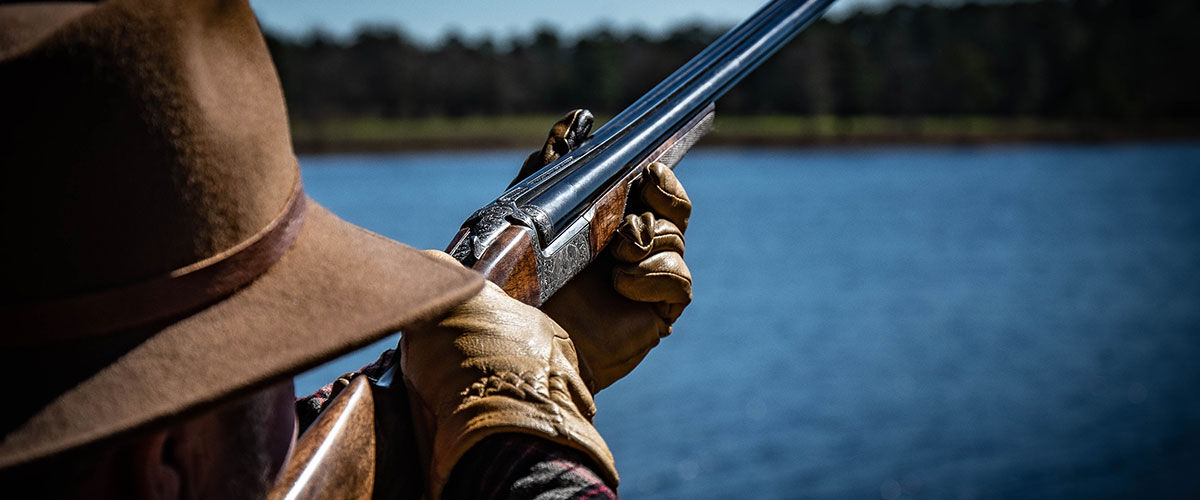 hunter aiming shotgun 