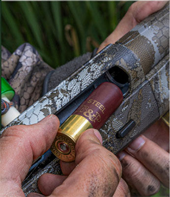 B&P shotshell being loaded into a shotgun