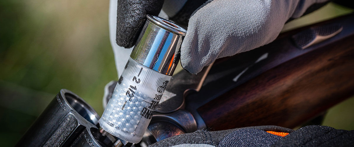 Upland Game Classic shotshell being loaded into a shotgun