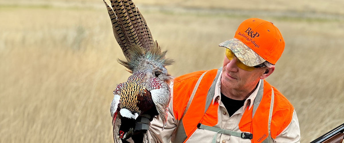 hunter holding pheasant